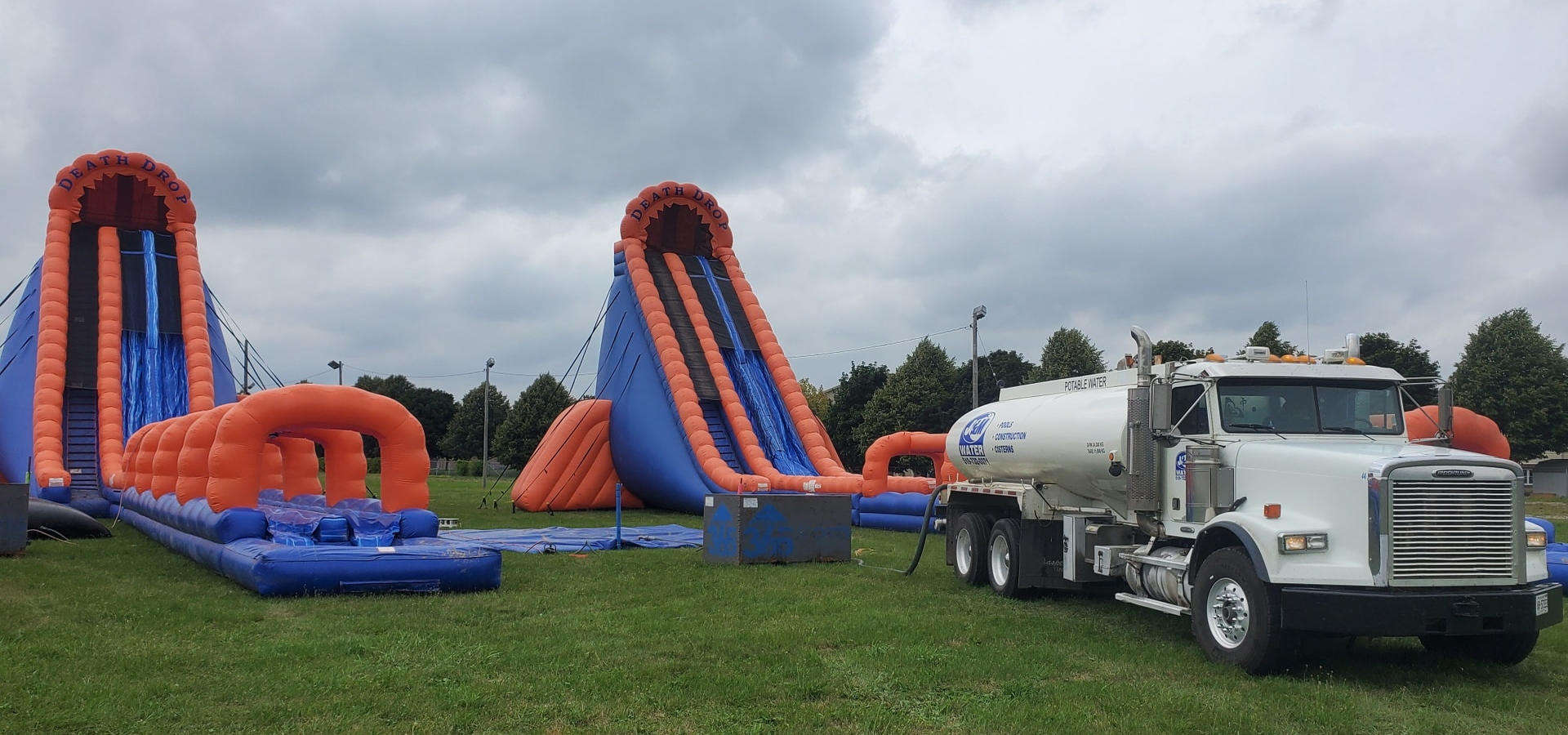 J and M Water Truck Inc. (Brantford) volunteer at a community event, delivering water for blow up water slide slides.