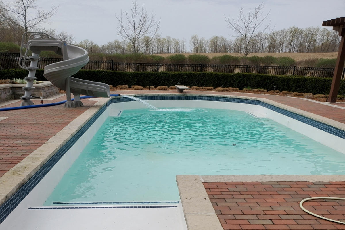 J and M Water Truck Inc. (Brantford), out of the picture save for the large hose/pipe, filling up a large residential swimming pool (in the picture).